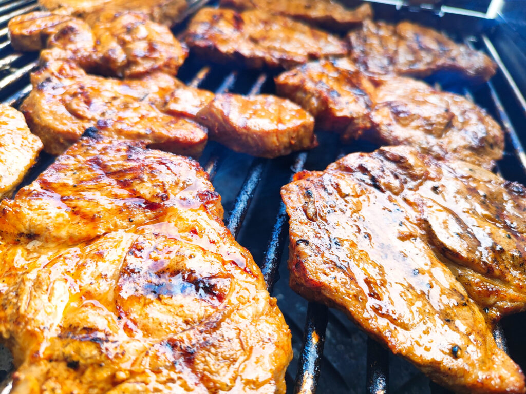 Saftige, marinierte Steaks auf einem Grill, zubereitet von Klein Catering – perfekt für BBQ-Events und Feiern im Kreis Herford